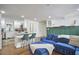 Open-concept living area with blue sectional sofa, kitchen island, and modern finishes at 1408 Ida St, Durham, NC 27705