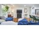 Inviting living room featuring a blue sectional, modern fireplace, and bar cart at 1408 Ida St, Durham, NC 27705