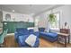 Stylish living room showcasing a blue sectional sofa and decorative wall accents at 1408 Ida St, Durham, NC 27705