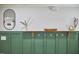 Stylish mud room with dark green wainscoting, hooks, and wood accents at 1408 Ida St, Durham, NC 27705