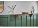 Stylish mud room with dark green wainscoting and hooks at 1408 Ida St, Durham, NC 27705