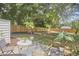 Backyard view with lush trees and outdoor patio furniture at 1408 Ida St, Durham, NC 27705