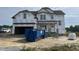 New two-story home with Tyvek wrap, covered entrance, and an attached two-car garage at 151 Retreat Run, Smithfield, NC 27577