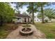 Charming backyard featuring a fire pit, patio, and mature shade trees at 1541 Shadylawn Dr, Burlington, NC 27215