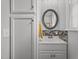 Bathroom featuring a vanity with a mirror, a sink with stylish accent tiles, and built in cabinet storage at 1541 Shadylawn Dr, Burlington, NC 27215