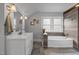 Elegant bathroom featuring a modern vanity, soaking tub, and stylish tile work at 1541 Shadylawn Dr, Burlington, NC 27215