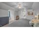 Cozy bedroom with neutral tones, plush carpet, and a charming vintage-inspired chair at 1541 Shadylawn Dr, Burlington, NC 27215