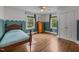 Well-lit bedroom with wood floors, large windows, and decorative wall accents at 1541 Shadylawn Dr, Burlington, NC 27215