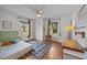 Bright, airy bedroom featuring two large windows with wood floors and ceiling fan at 1541 Shadylawn Dr, Burlington, NC 27215