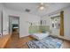 Bright bedroom featuring hardwood floors, a ceiling fan, and a colorful rug at 1541 Shadylawn Dr, Burlington, NC 27215