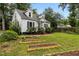 Charming Cape Cod-style house with dormers, garden beds, and a lush front lawn at 1541 Shadylawn Dr, Burlington, NC 27215
