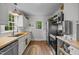 Bright, galley kitchen featuring butcher block countertops and stainless steel appliances at 1541 Shadylawn Dr, Burlington, NC 27215