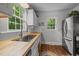 Well-lit kitchen with butcher block countertops, stainless steel refrigerator, and large sink at 1541 Shadylawn Dr, Burlington, NC 27215