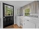 Well-lit laundry room featuring a window, washer, dryer, and exterior access at 1541 Shadylawn Dr, Burlington, NC 27215