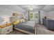 Main bedroom with a large window, neutral walls, and soft lighting at 1541 Shadylawn Dr, Burlington, NC 27215