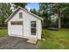 Exterior of a white shed with a sliding door, a regular door, and a trampoline in the yard at 1541 Shadylawn Dr, Burlington, NC 27215