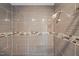 Stylish tiled shower with a shower head and decorative accent tiles at 1541 Shadylawn Dr, Burlington, NC 27215