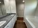 Bright bathroom featuring double sinks, and a tub perfect for relaxation at 180 Tulipfield Way, Benson, NC 27504