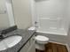 Well-maintained bathroom with a granite countertop, a sink, a toilet, and a bathtub-shower combo at 180 Tulipfield Way, Benson, NC 27504