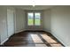 Sunlit bedroom with large windows, and neutral colored walls at 180 Tulipfield Way, Benson, NC 27504