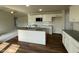 Bright kitchen boasting a central island, wooden floors, and ample cabinet space at 180 Tulipfield Way, Benson, NC 27504