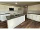 Modern kitchen featuring white cabinets, stainless steel appliances, and granite countertops at 180 Tulipfield Way, Benson, NC 27504
