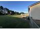 Private fenced backyard, featuring a wooden deck and an expanse of well-maintained grass at 195 Washington Ln, Cameron, NC 28326