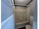 This bathtub shower combo features tile and is located in the bathroom with beadboard paneling at 195 Washington Ln, Cameron, NC 28326