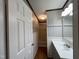 Bathroom showcasing vanity, framed mirror, beadboard paneling, and a tub shower combo at 195 Washington Ln, Cameron, NC 28326