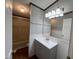The bathroom features beadboard paneling, vanity with framed mirror, and tub shower combo at 195 Washington Ln, Cameron, NC 28326