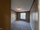 A bedroom with carpet, a window with blinds, baseboard trim, and paneled walls at 195 Washington Ln, Cameron, NC 28326
