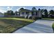 A well-maintained single-story home with a quaint front porch and a modern driveway at 195 Washington Ln, Cameron, NC 28326