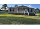 Welcoming single-story home featuring a charming front porch and manicured front yard at 195 Washington Ln, Cameron, NC 28326