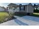 Inviting single-story home with a cozy front porch and a neatly paved driveway at 195 Washington Ln, Cameron, NC 28326