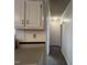 A hallway with neutral paint, baseboard trim, and access to other rooms at 195 Washington Ln, Cameron, NC 28326