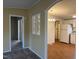 Hallway showing decorative windows, and entrances to the kitchen and bedrooms at 195 Washington Ln, Cameron, NC 28326