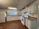 Traditional kitchen featuring white cabinets, laminate flooring, and ample counter space at 195 Washington Ln, Cameron, NC 28326