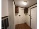 Laundry room with hookups, overhead cabinets, and a door to an adjacent space at 195 Washington Ln, Cameron, NC 28326