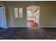 Living room view showcasing decorative windows with an archway leading to a kitchen with white cabinets at 195 Washington Ln, Cameron, NC 28326