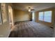 Spacious living room featuring neutral paint, plush carpeting, and a ceiling fan with lighting at 195 Washington Ln, Cameron, NC 28326