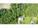 Aerial view of secluded home with expansive yard, mature trees, and long driveway at 200 Daniel Ridge Ln, Roxboro, NC 27574