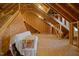 Unfinished attic space with wood framing and exposed plywood, offering potential for customization at 200 Daniel Ridge Ln, Roxboro, NC 27574