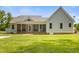 Spacious backyard featuring a well-maintained lawn and a charming screened porch at 200 Daniel Ridge Ln, Roxboro, NC 27574