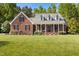 Lovely brick home with a well-manicured lawn and inviting covered porch at 200 Daniel Ridge Ln, Roxboro, NC 27574