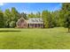 Charming brick home featuring a welcoming front porch and lush, green lawn at 200 Daniel Ridge Ln, Roxboro, NC 27574