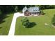 Two-story home with manicured lawn, long driveway, brick facade, and covered front porch at 200 Daniel Ridge Ln, Roxboro, NC 27574