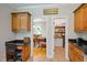 Open concept kitchen with a desk area that leads to a dining room and pantry with ample storage space at 200 Daniel Ridge Ln, Roxboro, NC 27574