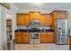 Well-lit kitchen featuring wood cabinetry, stainless steel appliances, and dark granite countertops at 200 Daniel Ridge Ln, Roxboro, NC 27574
