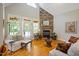 Comfortable living room featuring a stone fireplace, hardwood floors, and natural light at 200 Daniel Ridge Ln, Roxboro, NC 27574