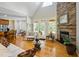 Bright living room boasts hardwood floors, a stone fireplace, and large windows at 200 Daniel Ridge Ln, Roxboro, NC 27574